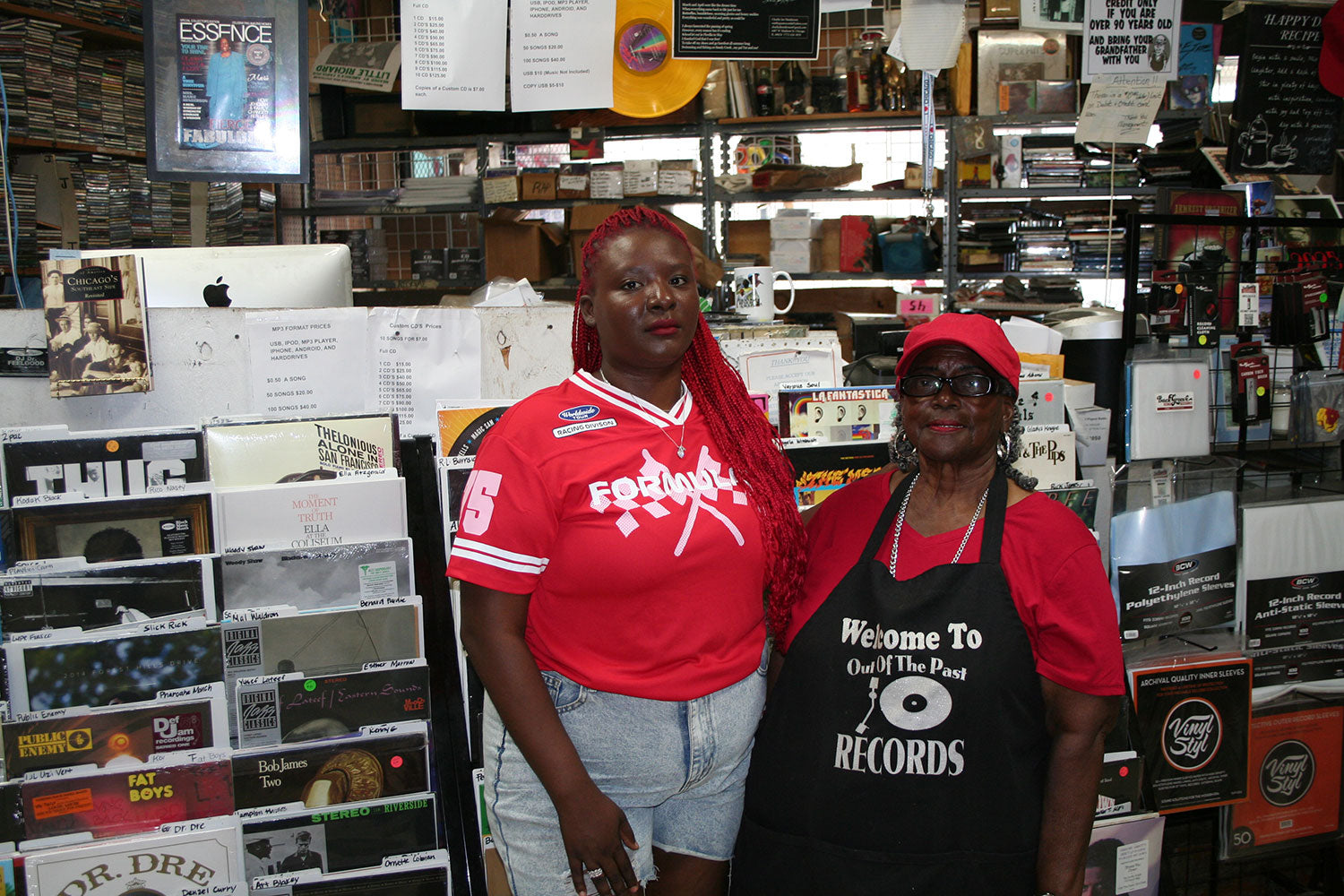 Annisa Gooden and Marie Henderson inside Out of the Past Records, surrounded by decades of vinyl records and music memorabilia at 4407 W. Madison Street, Chicago